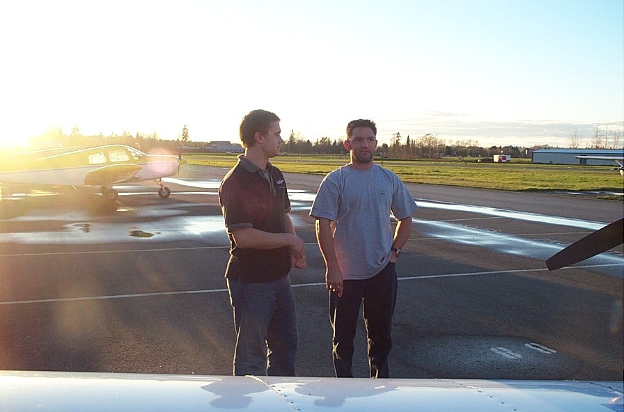 Flight Instructor Ryan Gahan confers with his student, James Ryan, just prior to Jame's Flight Test.  Both are graduates of Langley Flying School.  Ryan Gahan is now a Saab 340 pilot with Pacific Coastal Airlines. Langley Flying School